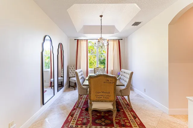 a dining room with furniture and a chandelier
