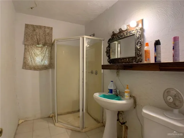 a bathroom with a sink a toilet and mirror