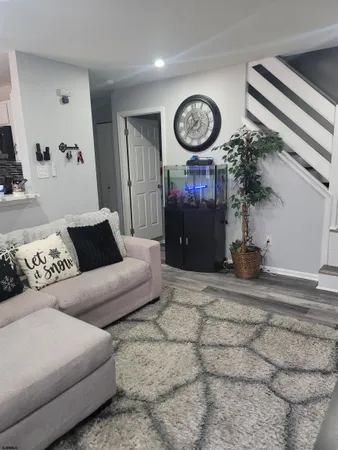 a living room with fireplace furniture and a mirror