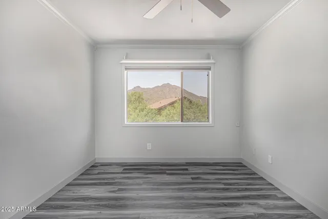 an empty room with wooden floor and a window