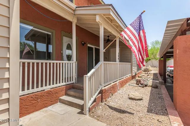 a view of a house with a small yard and wooden floor and fence