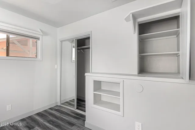 a view of walk in closet with empty racks