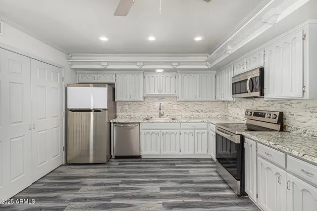 a kitchen with a sink stove and refrigerator