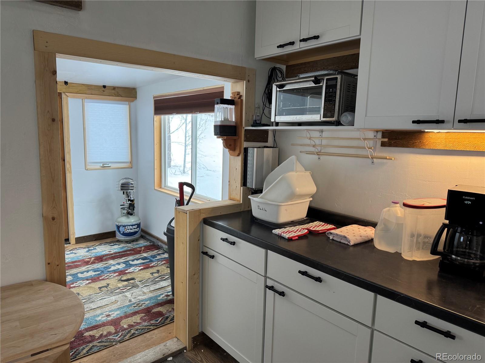 1666 Singletree Road Hartsel, CO 80449 - Photo 11 of 37 a kitchen with stainless steel appliances a stove and cabinets