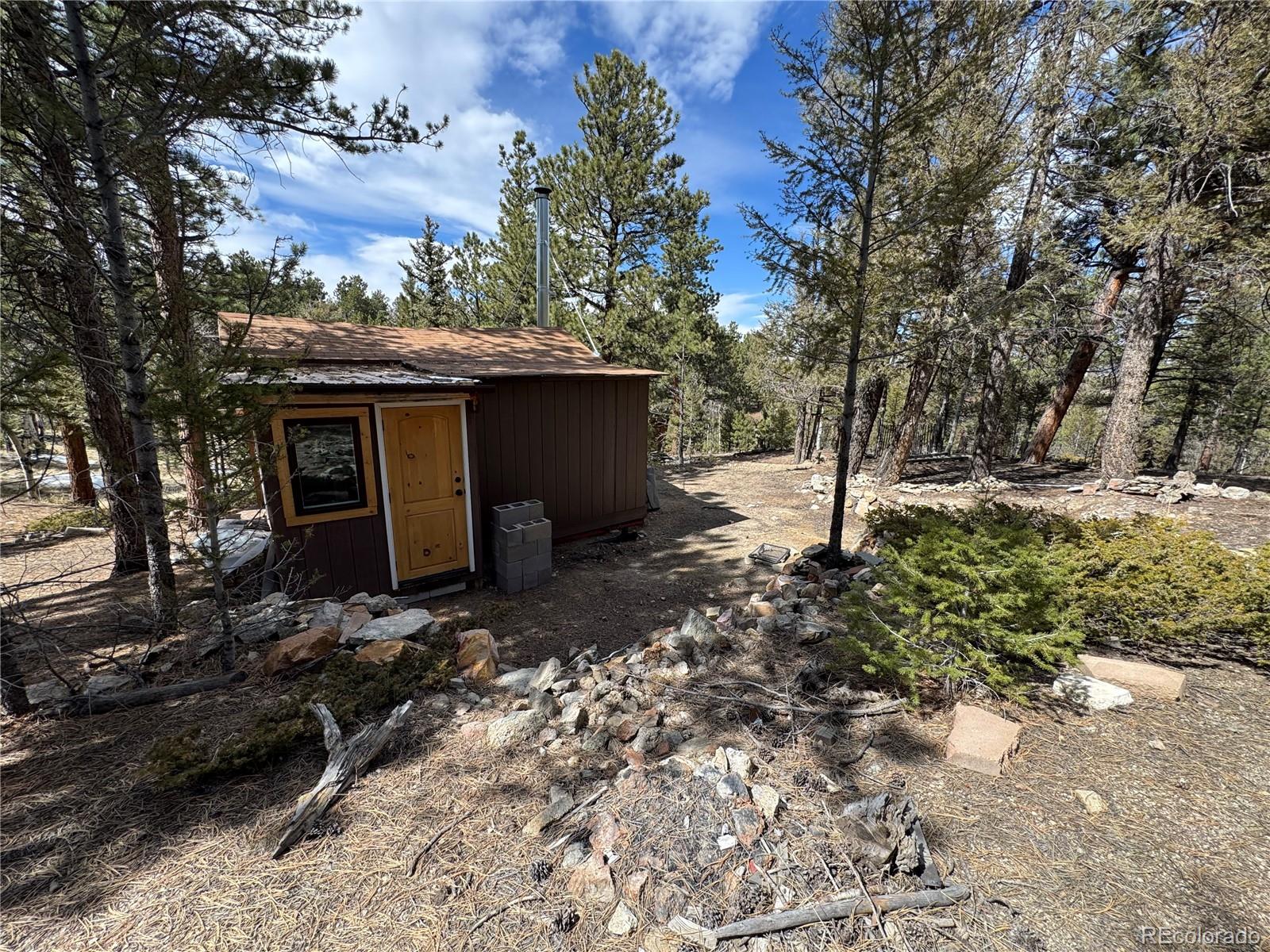 1666 Singletree Road Hartsel, CO 80449 - Photo 17 of 37 a view of a house with a yard