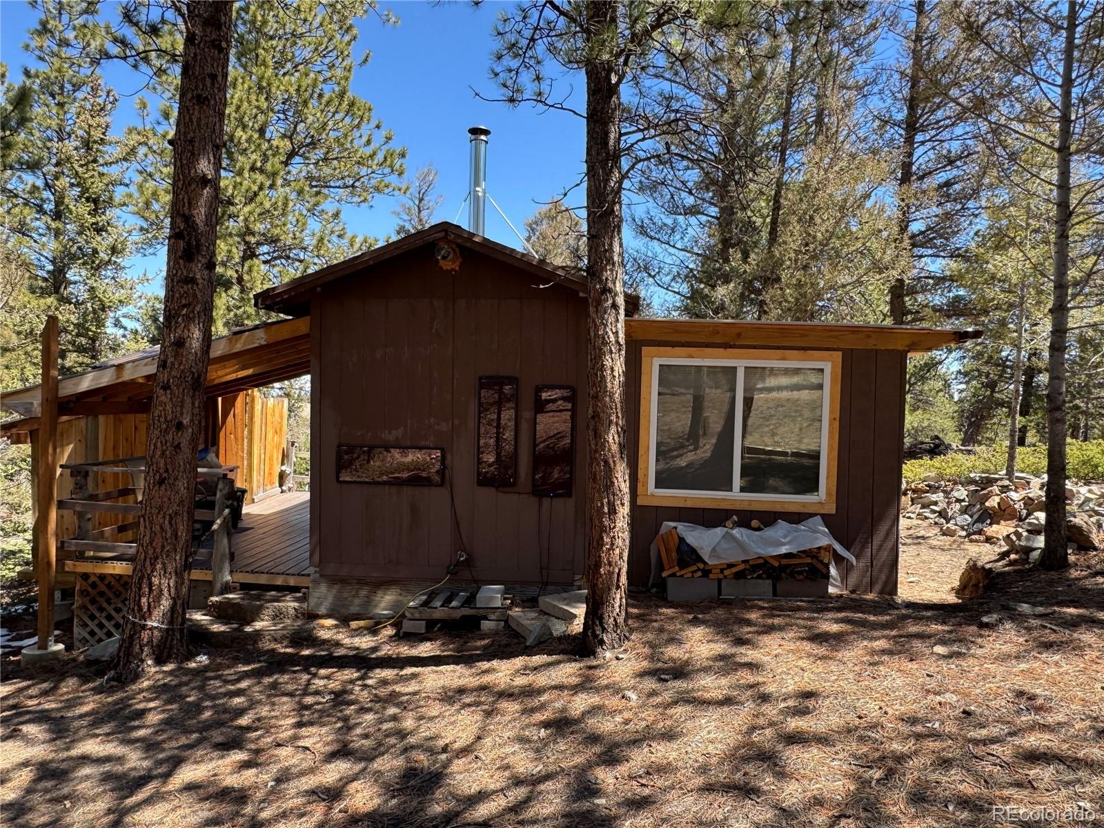 1666 Singletree Road Hartsel, CO 80449 - Photo 35 of 37 a view of a house with backyard and trees