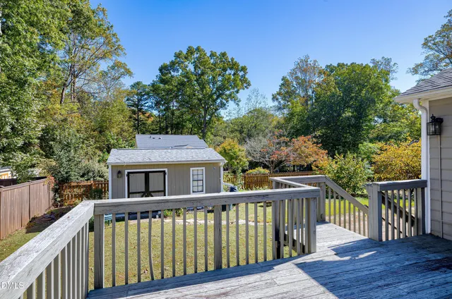 a balcony with wooden floor and fence