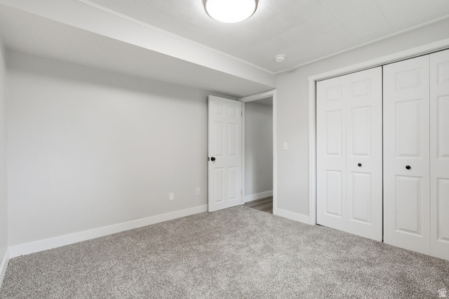 629 King Circle Layton, UT 84041 - Photo 23 of 26 Room with light grey wall paint and light grey carpet flooring