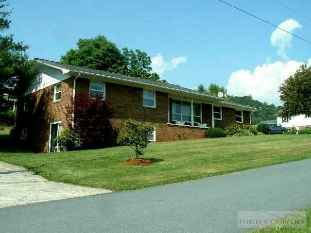 185 Deer Street Boone, NC 28607 - Photo 1 of 1 a front view of a house with a garden