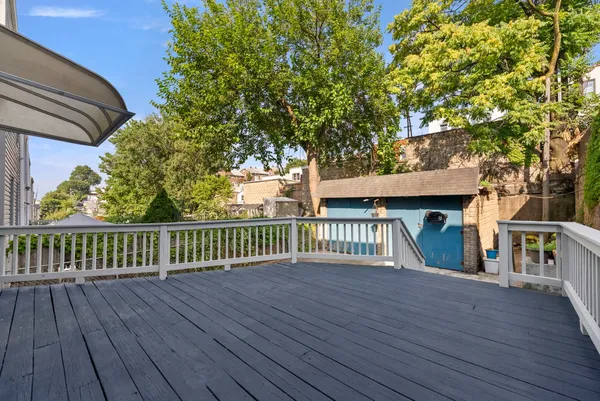 a view of backyard with a deck and wooden floor