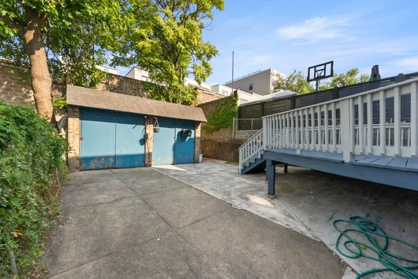 a view of a house with a yard and deck