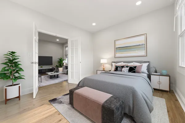 a bedroom with bed and a potted plant