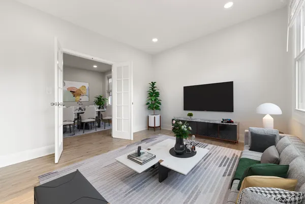 a living room with furniture flat screen tv and wooden floor