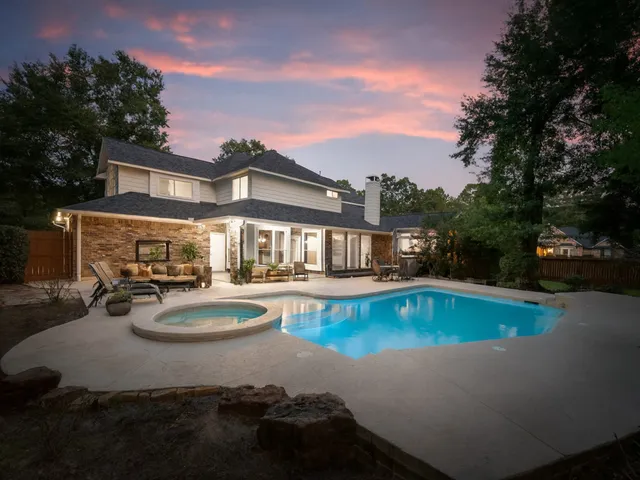 a view of a house with swimming pool and sitting area