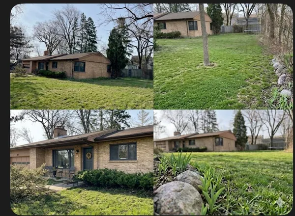 a view of a house with backyard and garden