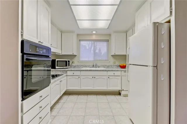 a kitchen with granite countertop stainless steel appliances and countertop cabinets