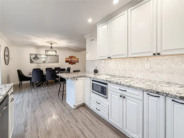 a kitchen with sink cabinets and dining table