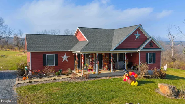 a front view of house with yard and outdoor seating