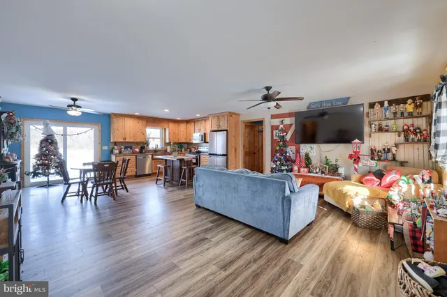 a dining room filled kitchen with a wooden table and chairs