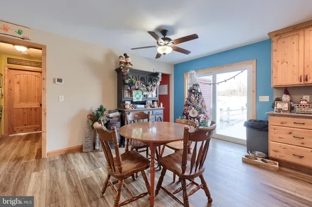 a kitchen with granite countertop a refrigerator stove microwave and cabinets
