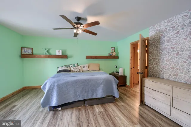 a bathroom with a granite countertop sink a mirror and a shower