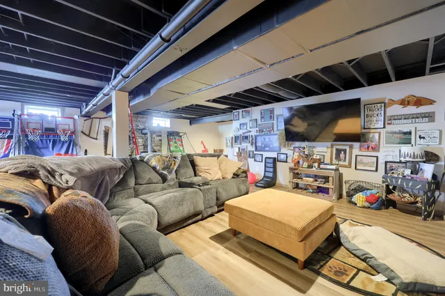 a room with wooden floors and lots of furniture