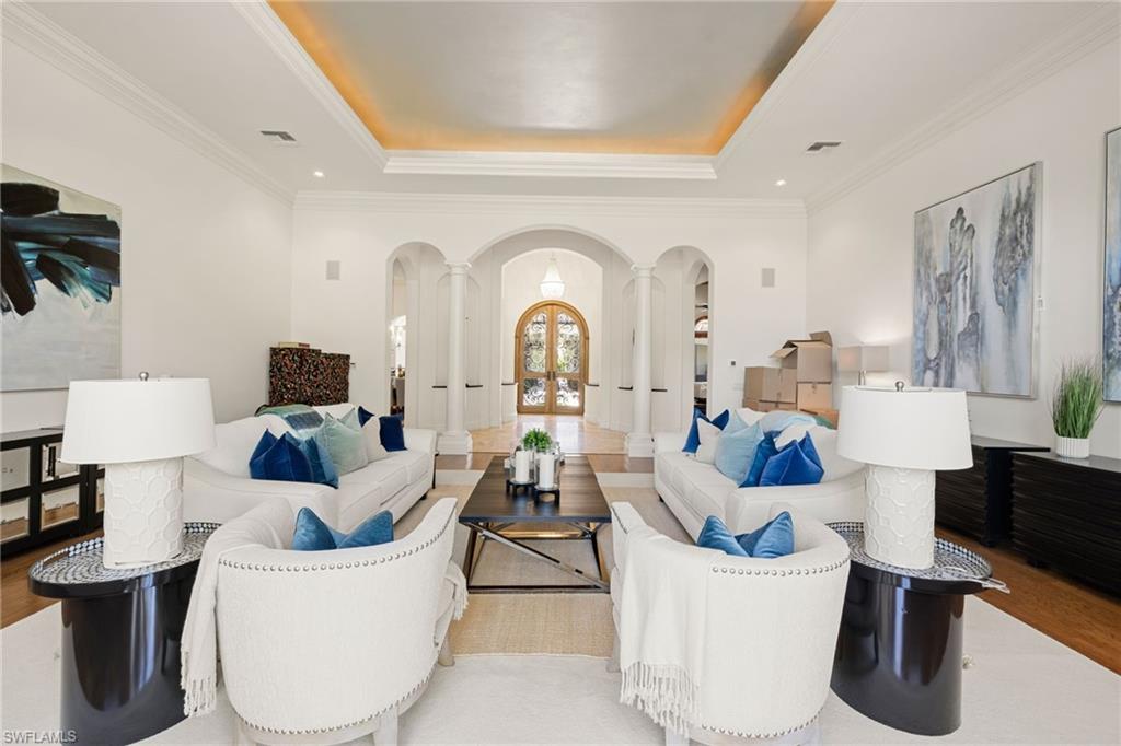 185 Tupelo Road Naples, FL 34108 - Photo 11 of 44 a living room with furniture a couch and a chandelier