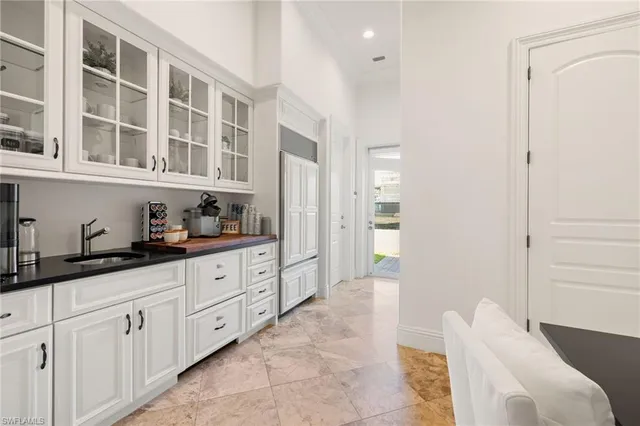 a large white kitchen with stainless steel appliances