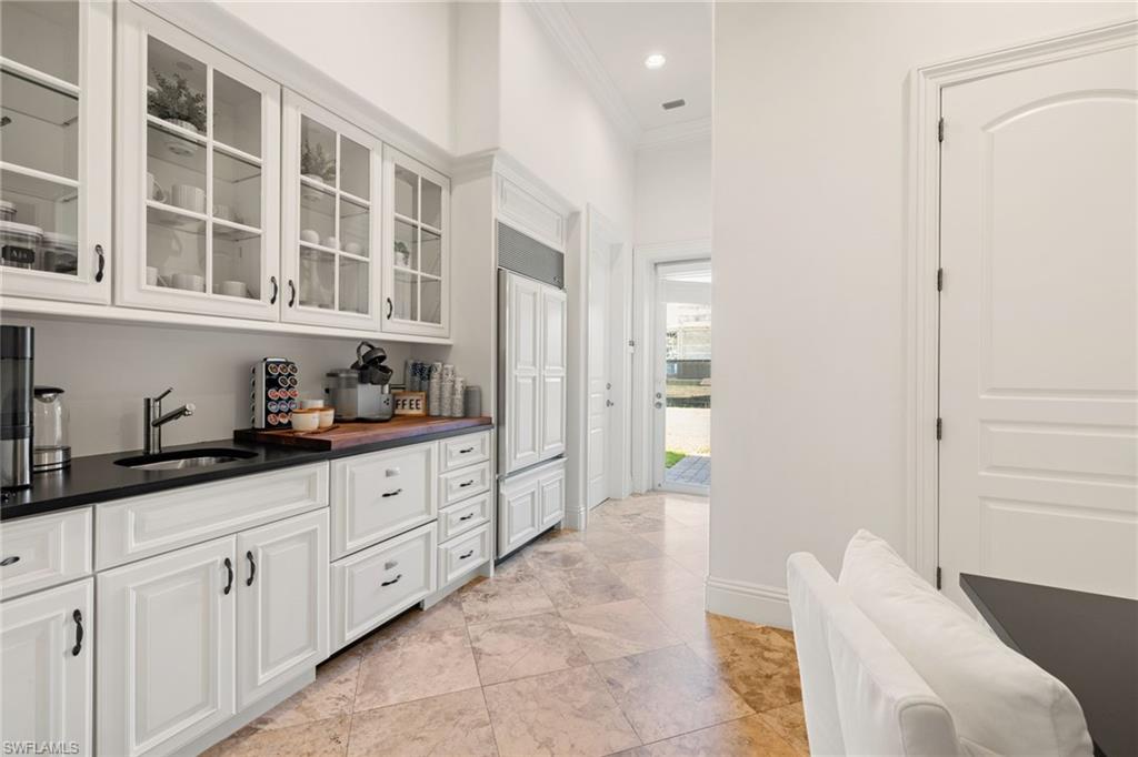 185 Tupelo Road Naples, FL 34108 - Photo 15 of 44 a spacious bathroom with a granite countertop sink and a mirror