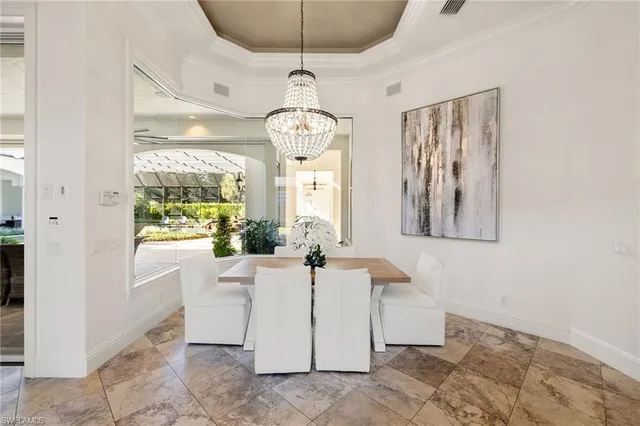 a kitchen with kitchen island a stove a table a sink a counter top space and cabinets