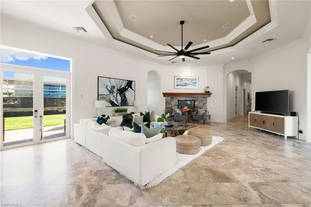 a view of a hallway with windows and chandelier