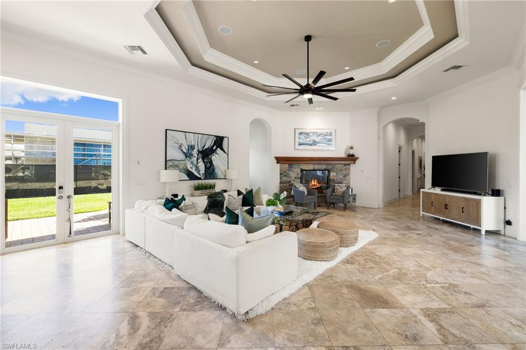 185 Tupelo Road Naples, FL 34108 - Photo 18 of 44 a living room with furniture and a flat screen tv