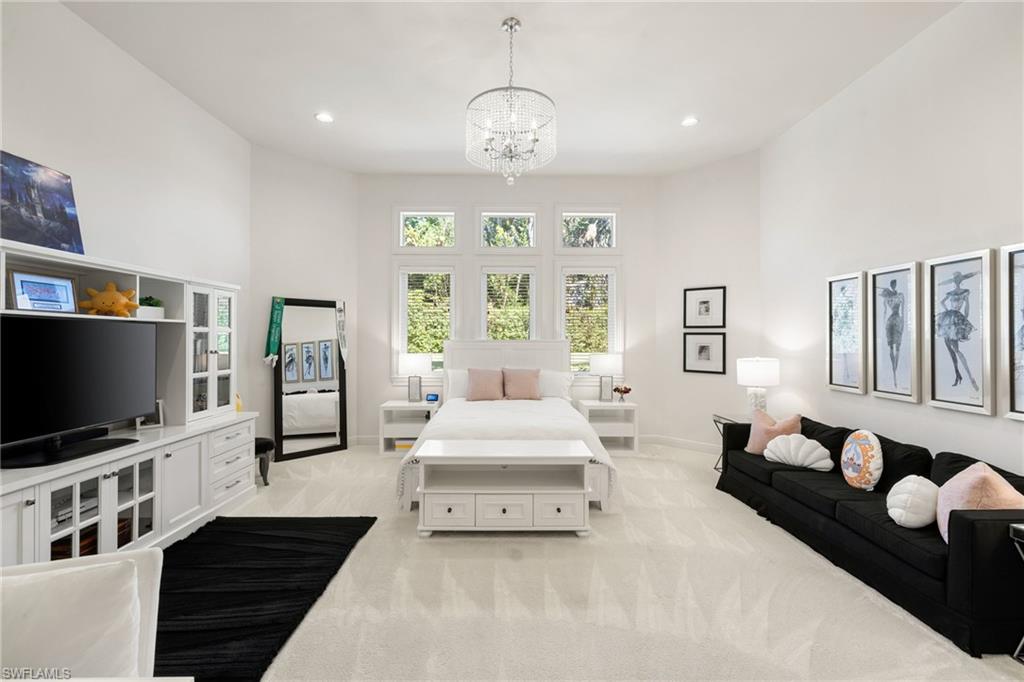 185 Tupelo Road Naples, FL 34108 - Photo 26 of 44 a spacious bedroom with a bed and a flat screen tv