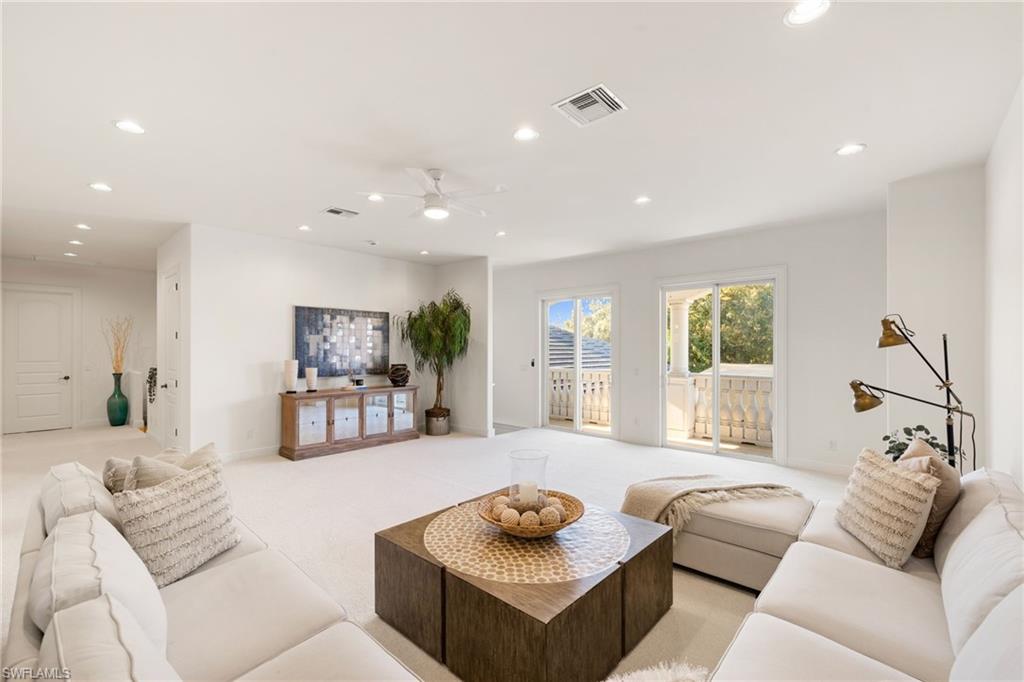 185 Tupelo Road Naples, FL 34108 - Photo 28 of 44 a living room with furniture and a large window