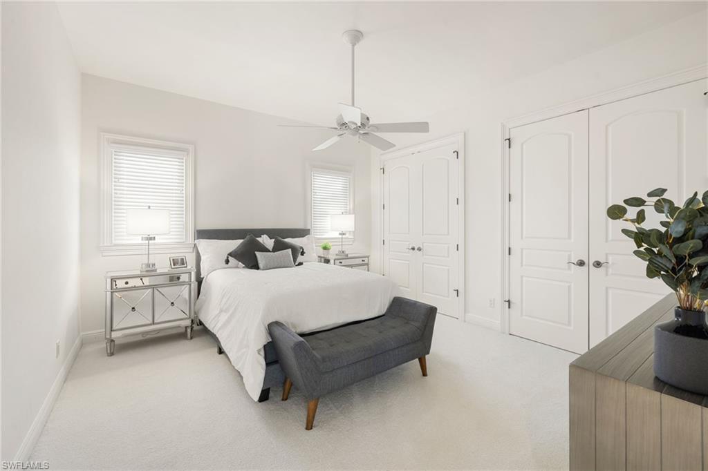 185 Tupelo Road Naples, FL 34108 - Photo 29 of 44 a spacious bedroom with a bed and a chandelier