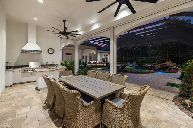 a dining room with furniture and a large window