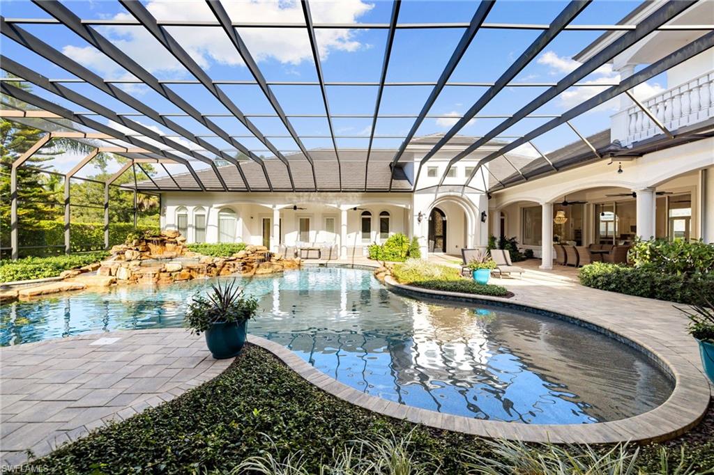 185 Tupelo Road Naples, FL 34108 - Photo 39 of 44 a view of a swimming pool with outdoor seating