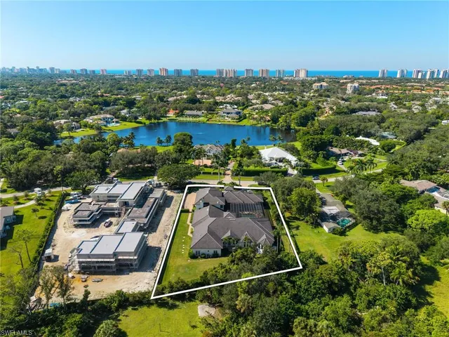 a front view of a house with a garden and yard