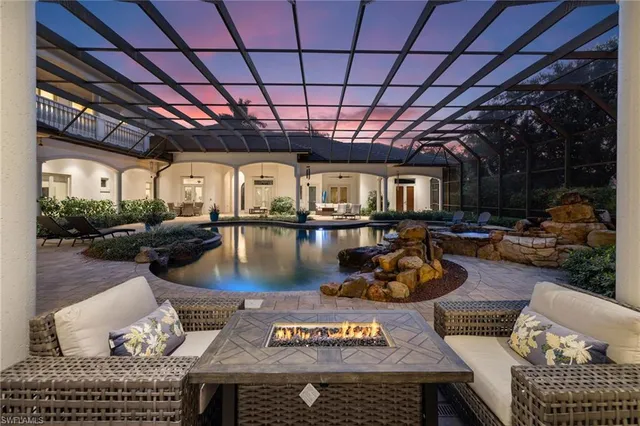 a room with lots of furniture and a chandelier