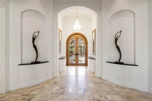 a view of a hallway with entryway wooden floor and front door