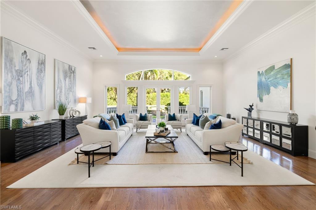 185 Tupelo Road Naples, FL 34108 - Photo 10 of 44 a living room with furniture and a large window