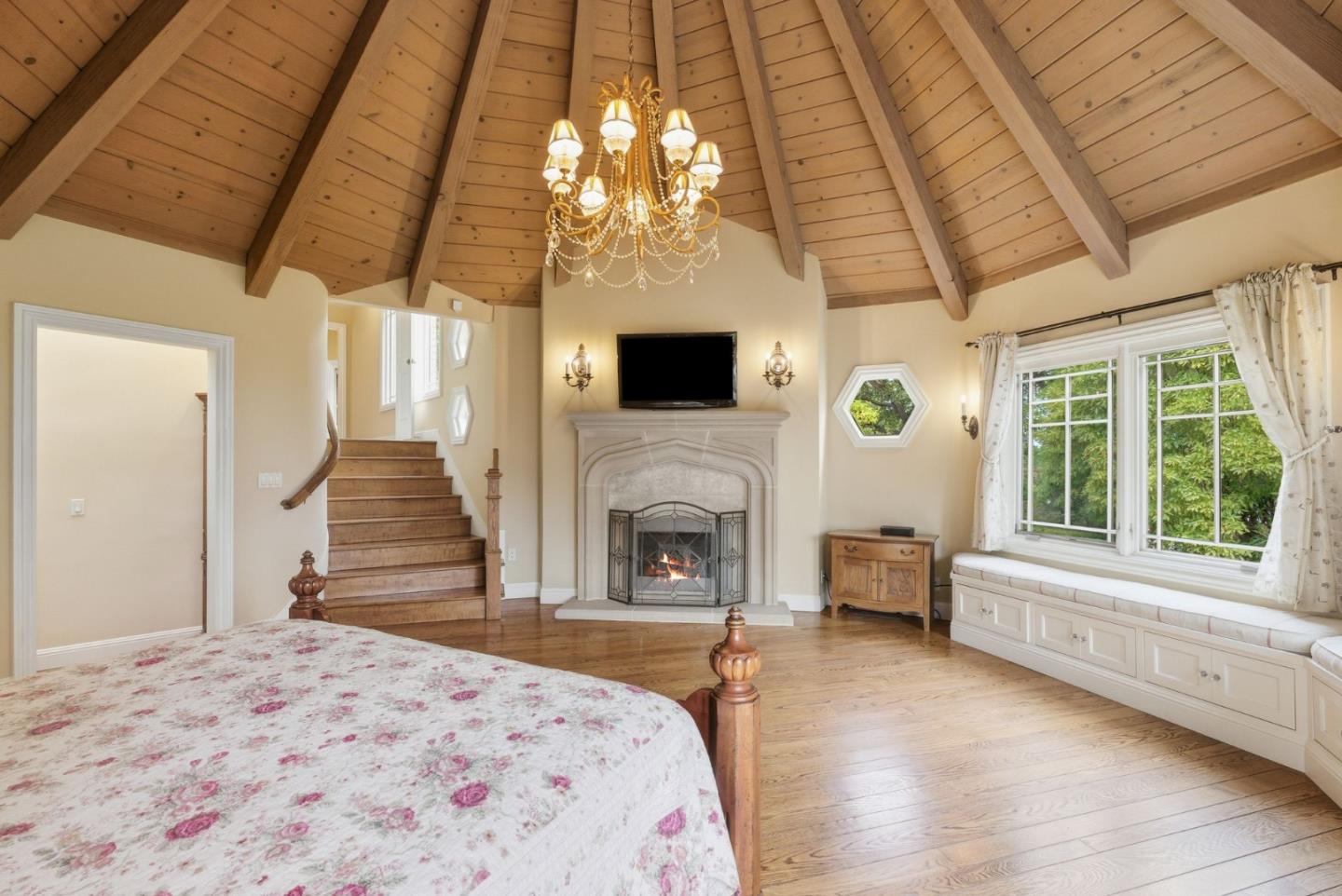 23423 Toyonita Road Los Altos Hills, CA 94024 - Photo 20 of 59 a spacious bedroom with a bed and a fireplace