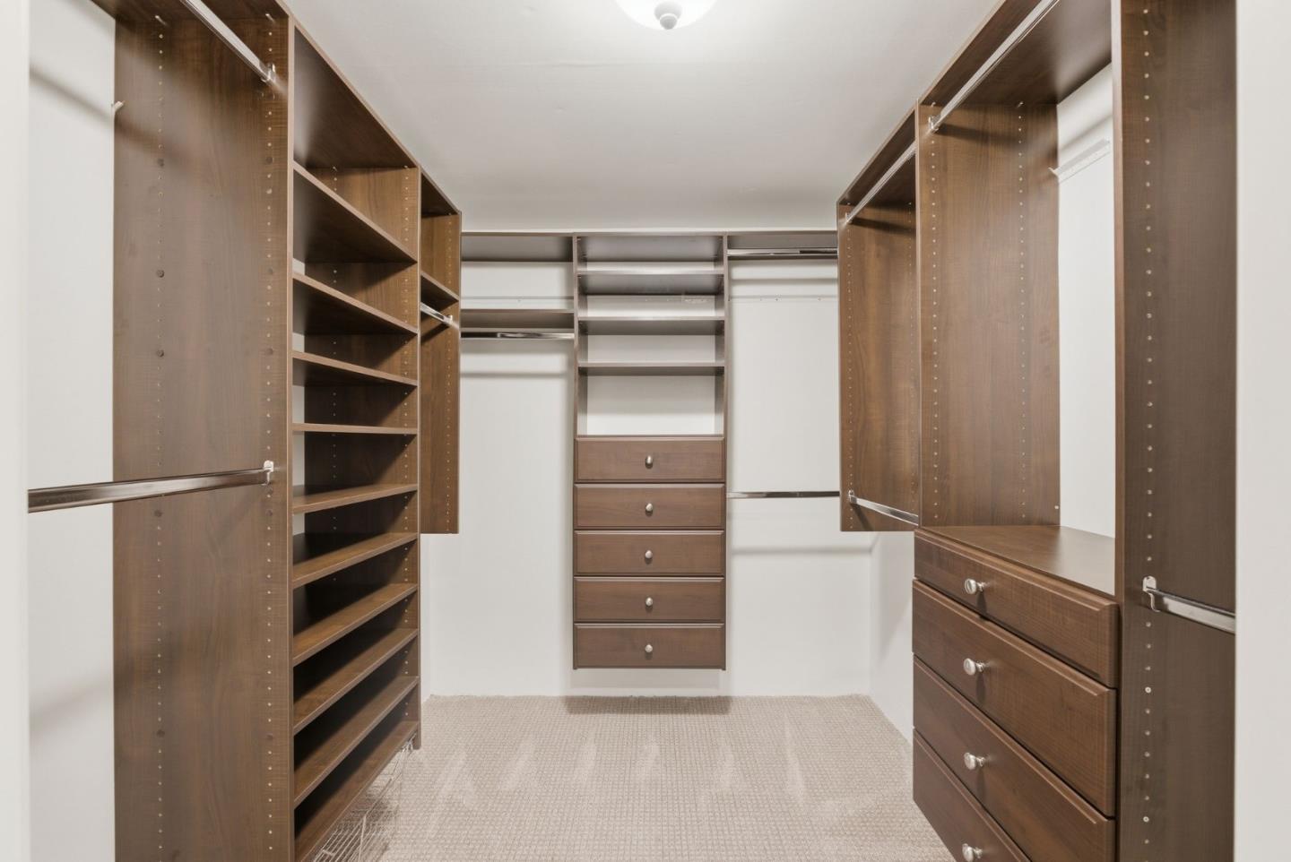 23423 Toyonita Road Los Altos Hills, CA 94024 - Photo 27 of 59 a view of walk in closet with empty racks