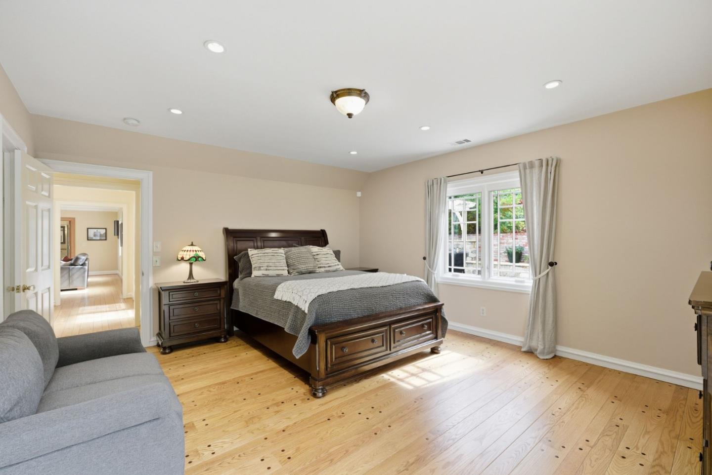 23423 Toyonita Road Los Altos Hills, CA 94024 - Photo 37 of 59 a spacious bedroom with a bed and wooden floor