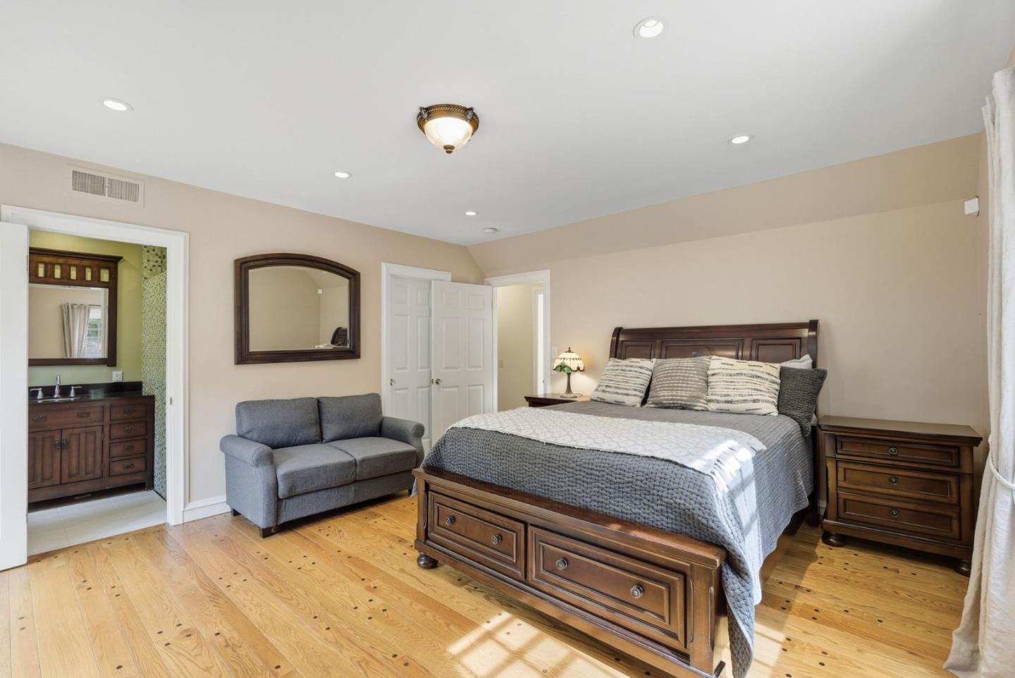 23423 Toyonita Road Los Altos Hills, CA 94024 - Photo 38 of 59 a spacious bedroom with a bed and a couch
