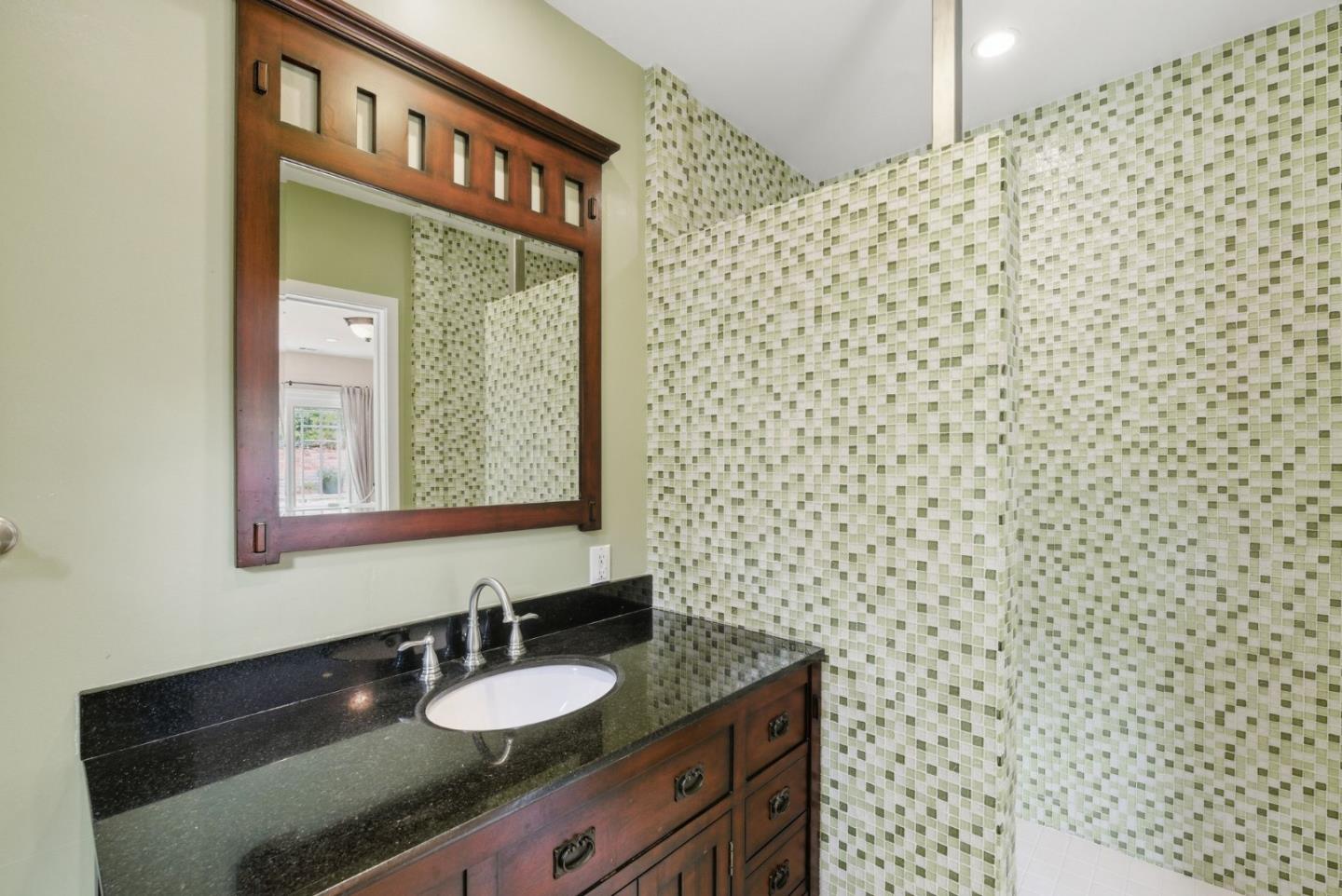 23423 Toyonita Road Los Altos Hills, CA 94024 - Photo 39 of 59 a bathroom with a granite countertop sink with a mirror