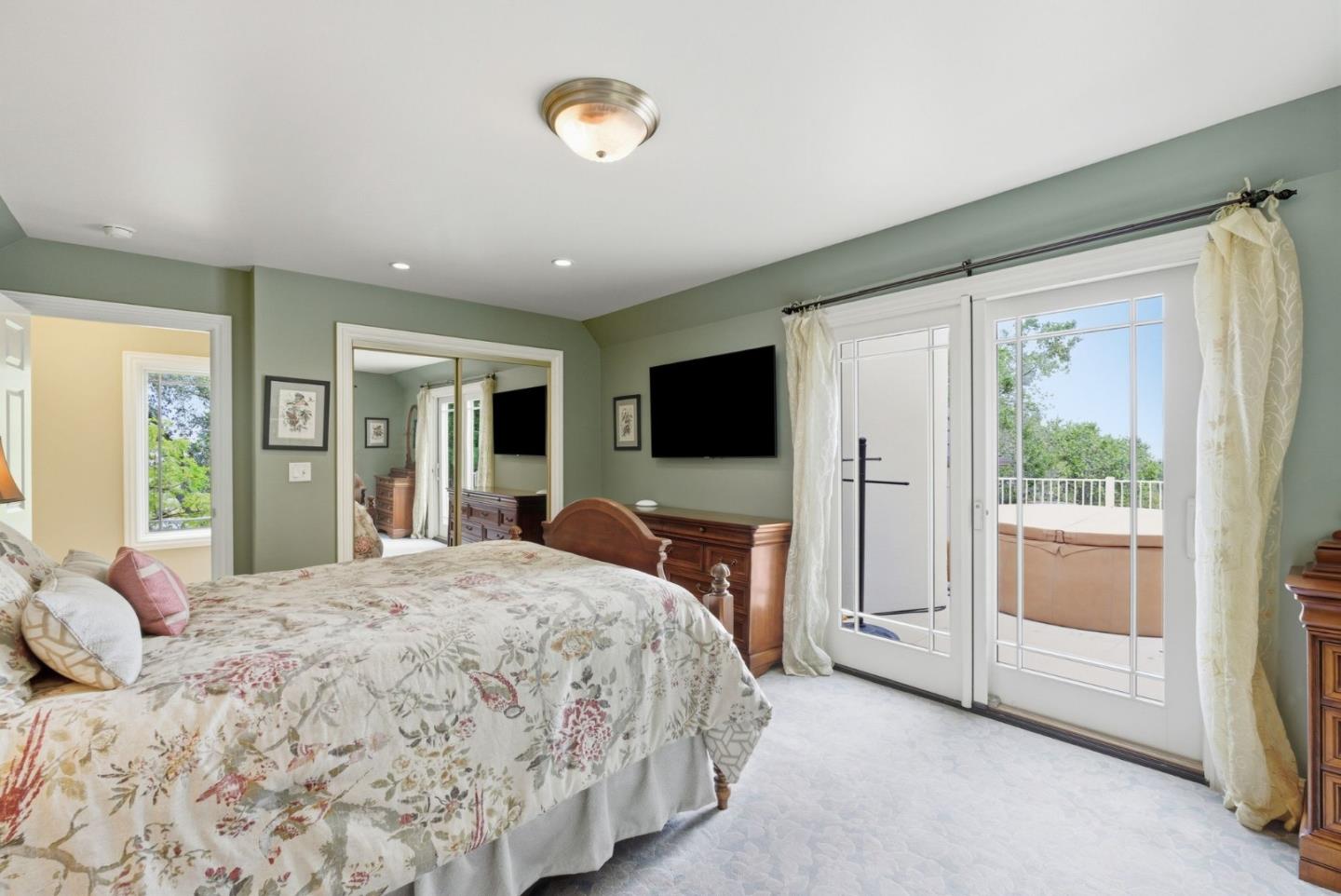 23423 Toyonita Road Los Altos Hills, CA 94024 - Photo 46 of 59 a bedroom with a bed and a flat screen tv