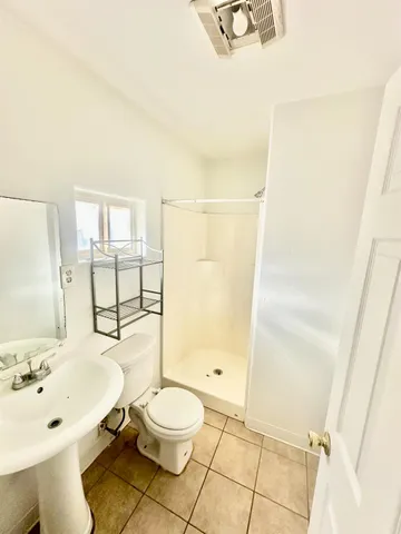 a bathroom with a sink mirror toilet and shower