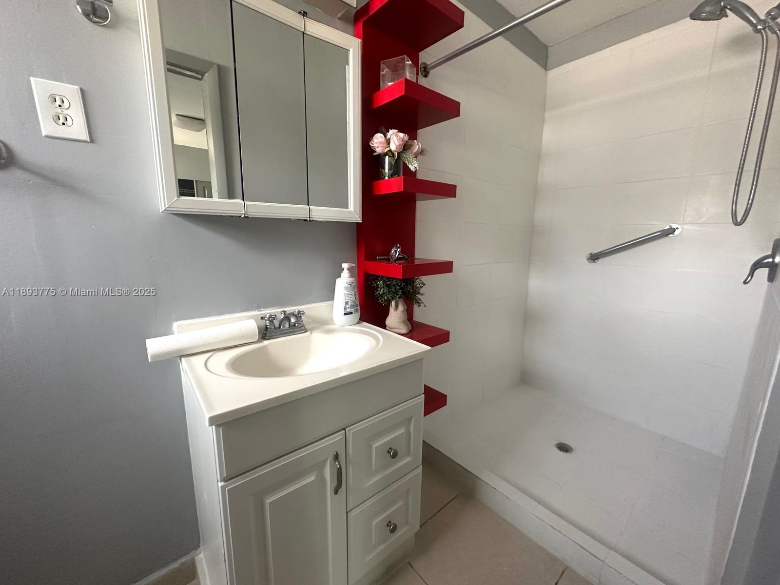 4361 Southwest 3rd Street, Unit 1 Miami, FL 33134 - Photo 2 of 11 a bathroom with a sink a vanity and a shower