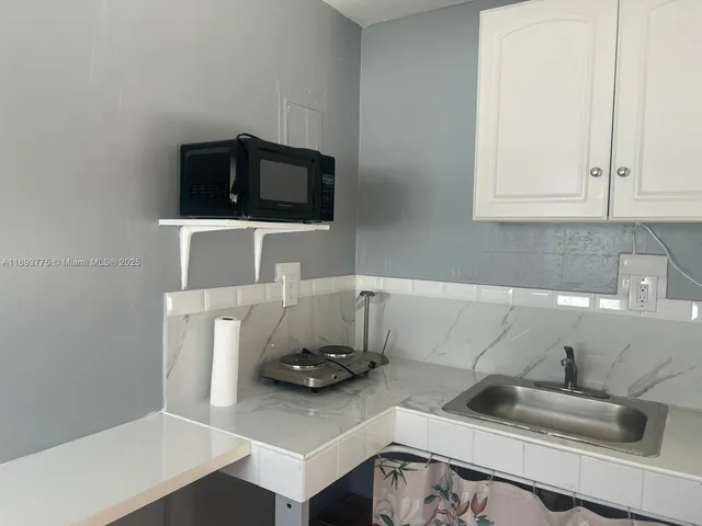 a backyard of a house with wooden floor table and chairs